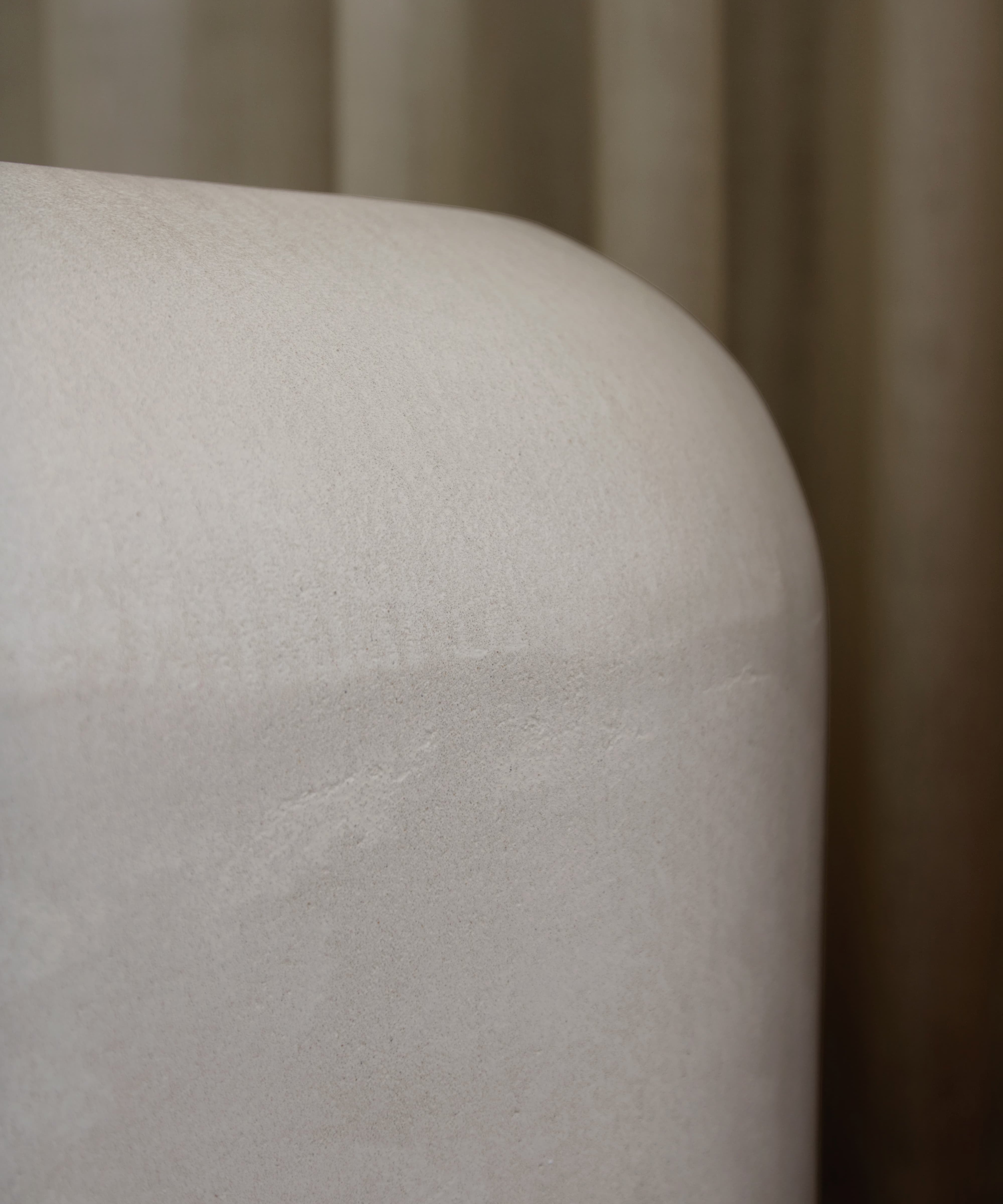 Close-up of Clay Crème showing a subtle, fine grain across its tactile surface and softly rounded edge.