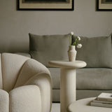 MAIE Clay Crème nesting tables featuring a subtly grained surface, styled with flowers and books in a neutral living room.