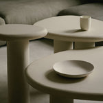 Organic-shaped nesting tables in Clay Crème with a subtly grained surface and rounded, asymmetrical form.