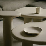 Organic-shaped nesting tables in Clay Crème with a subtly grained surface and rounded, asymmetrical form.