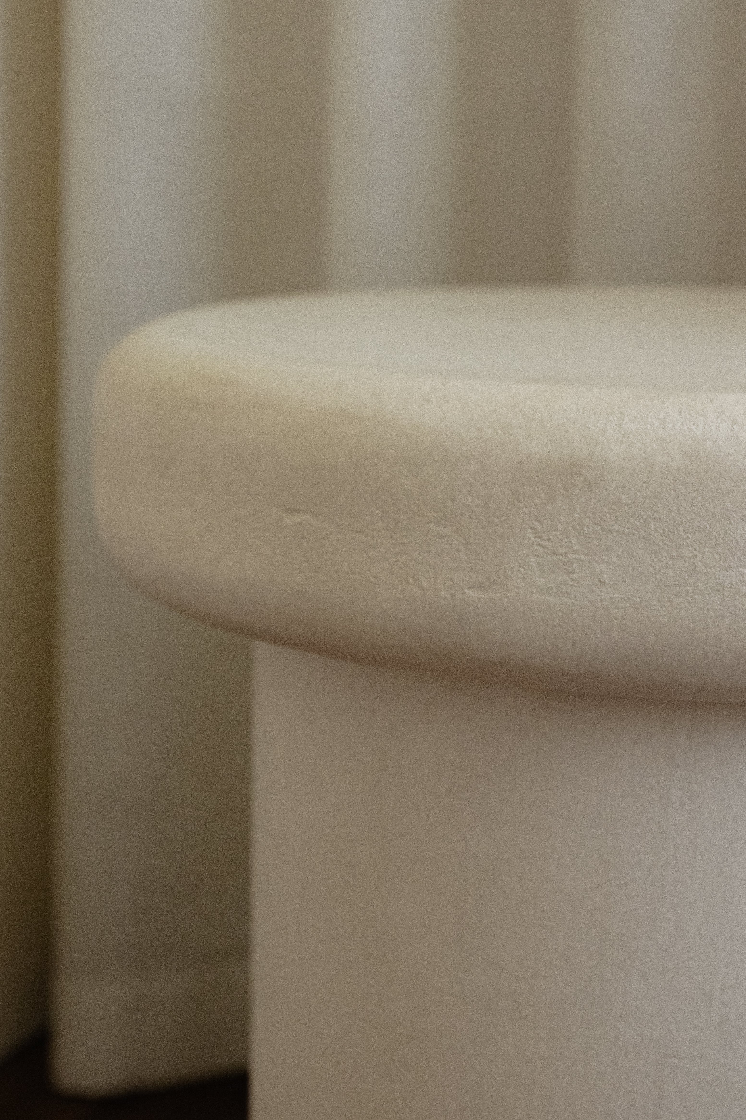 Close-up of Clay Duvet showing a subtle, fine grain across its tactile surface and softly rounded edge.