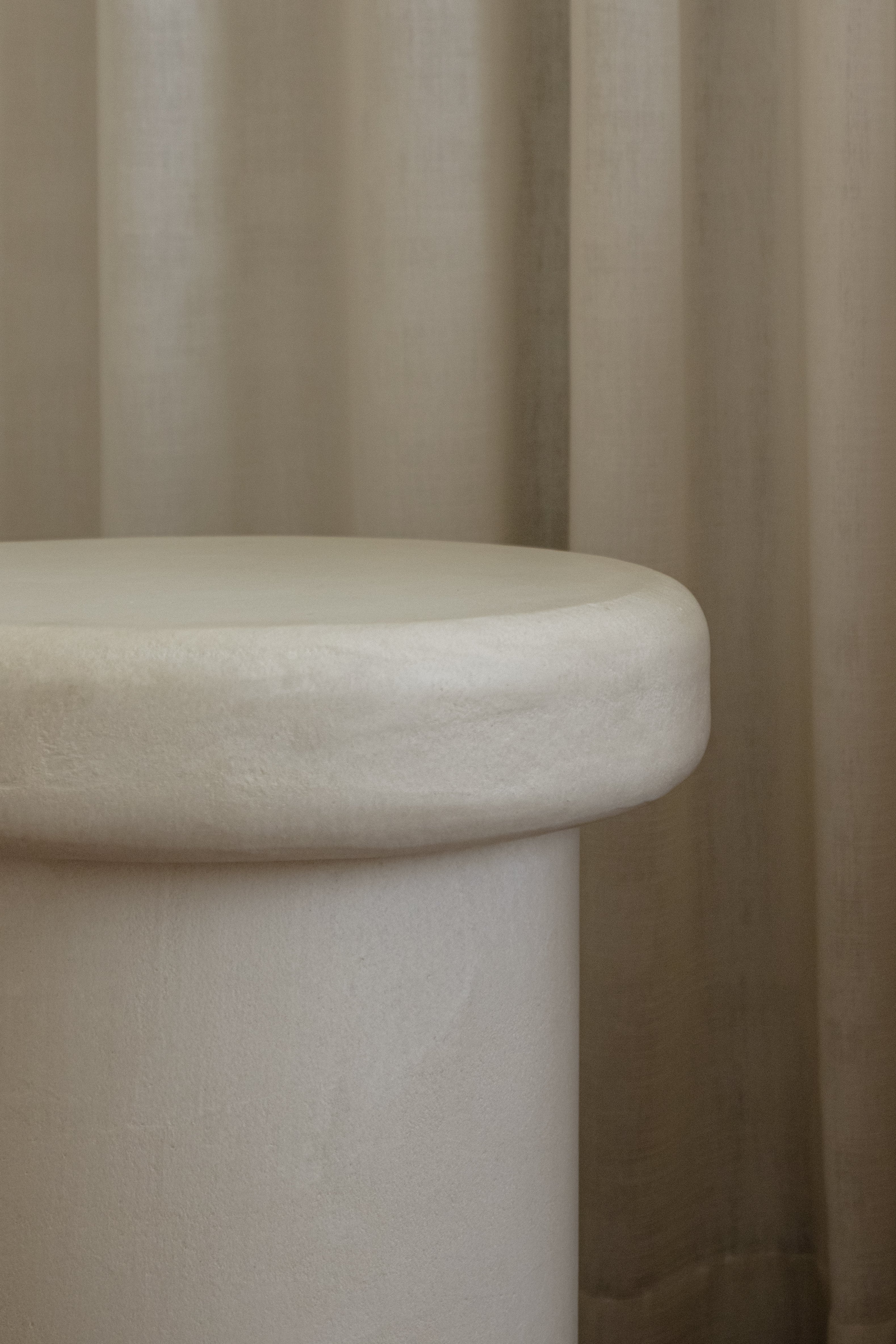 Close-up of Clay Duvet showing a subtle, fine grain across its tactile surface and softly rounded edge.
