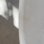 Close-up of Clay Duvet showing a subtle, fine grain across its tactile surface and softly rounded edge.