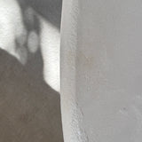 Close-up of Clay Duvet showing a subtle, fine grain across its tactile surface and softly rounded edge.