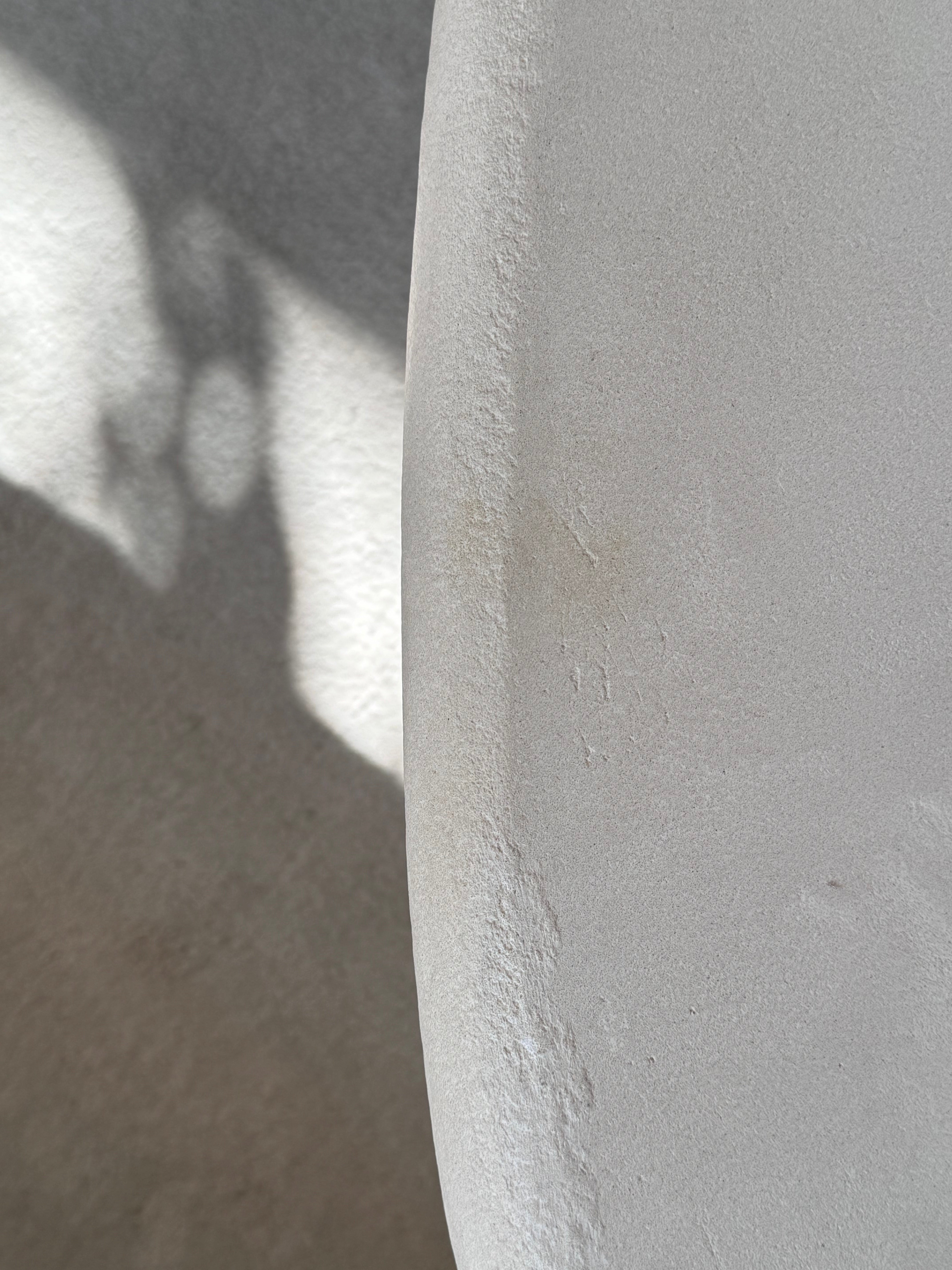 Close-up of Clay Duvet showing a subtle, fine grain across its tactile surface and softly rounded edge.