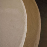 Close-up of Clay Duvet showing a subtle, fine grain across its tactile surface and softly rounded edge.