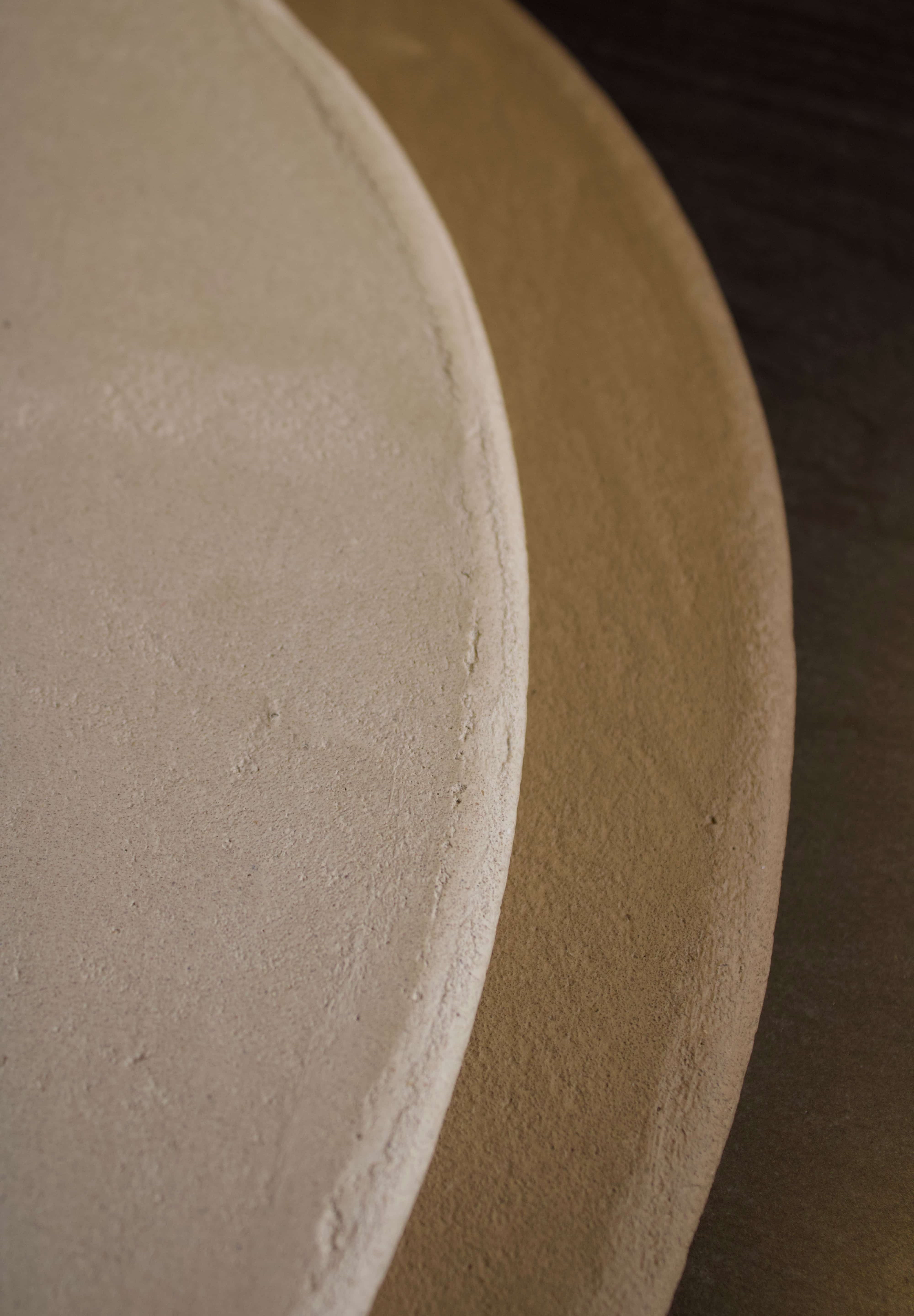 Close-up of Clay Duvet showing a subtle, fine grain across its tactile surface and softly rounded edge.
