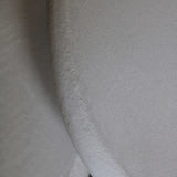 Close-up of Clay Duvet showing a subtle, fine grain across its tactile surface and softly rounded edge.