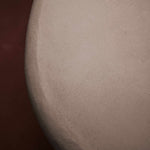 Close-up of Clay Duvet showing a subtle, fine grain across its tactile surface and softly rounded edge.