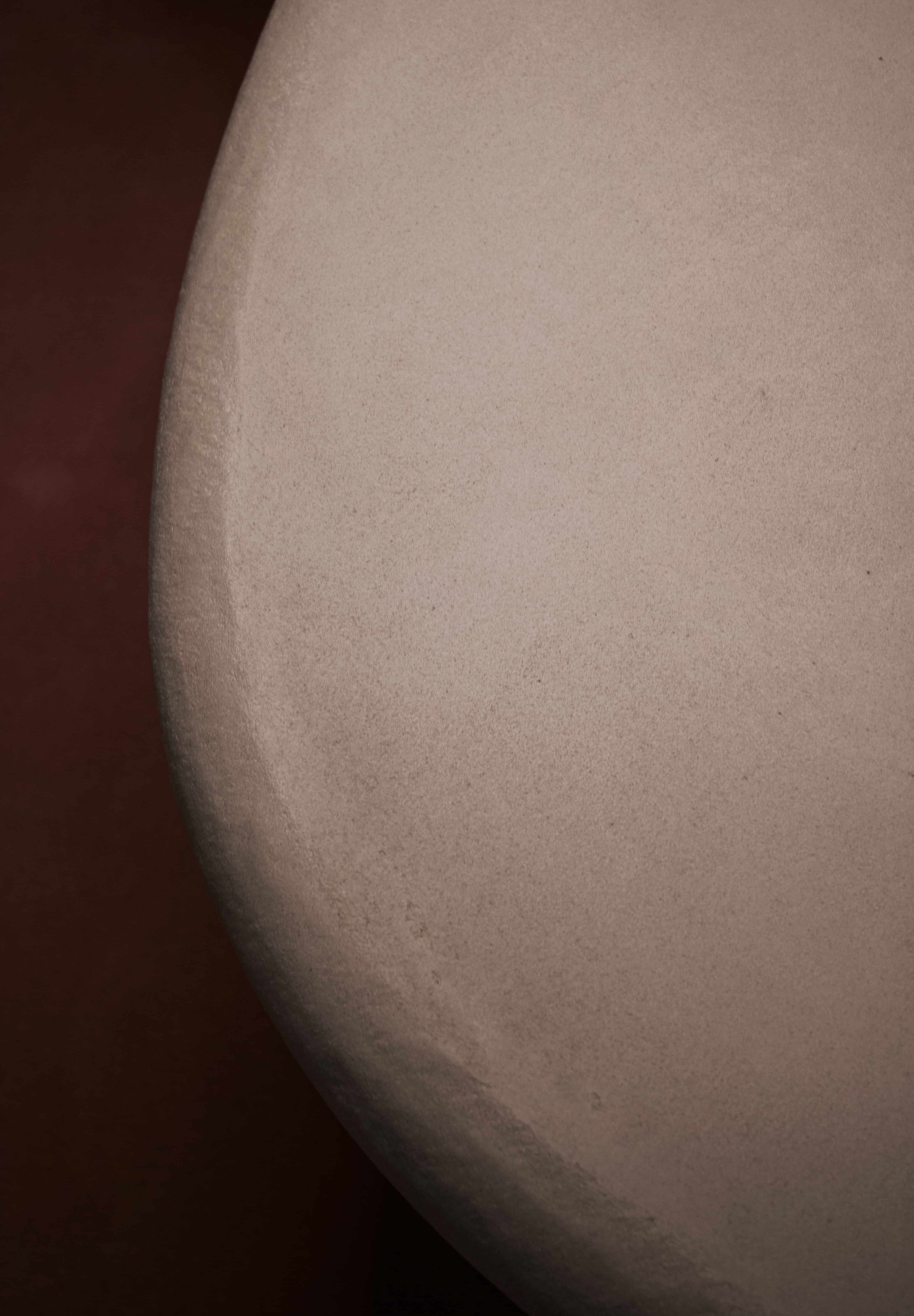 Close-up of Clay Duvet showing a subtle, fine grain across its tactile surface and softly rounded edge.