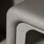 Close-up of Clay Duvet showing a subtle, fine grain across its tactile surface and softly rounded edge.