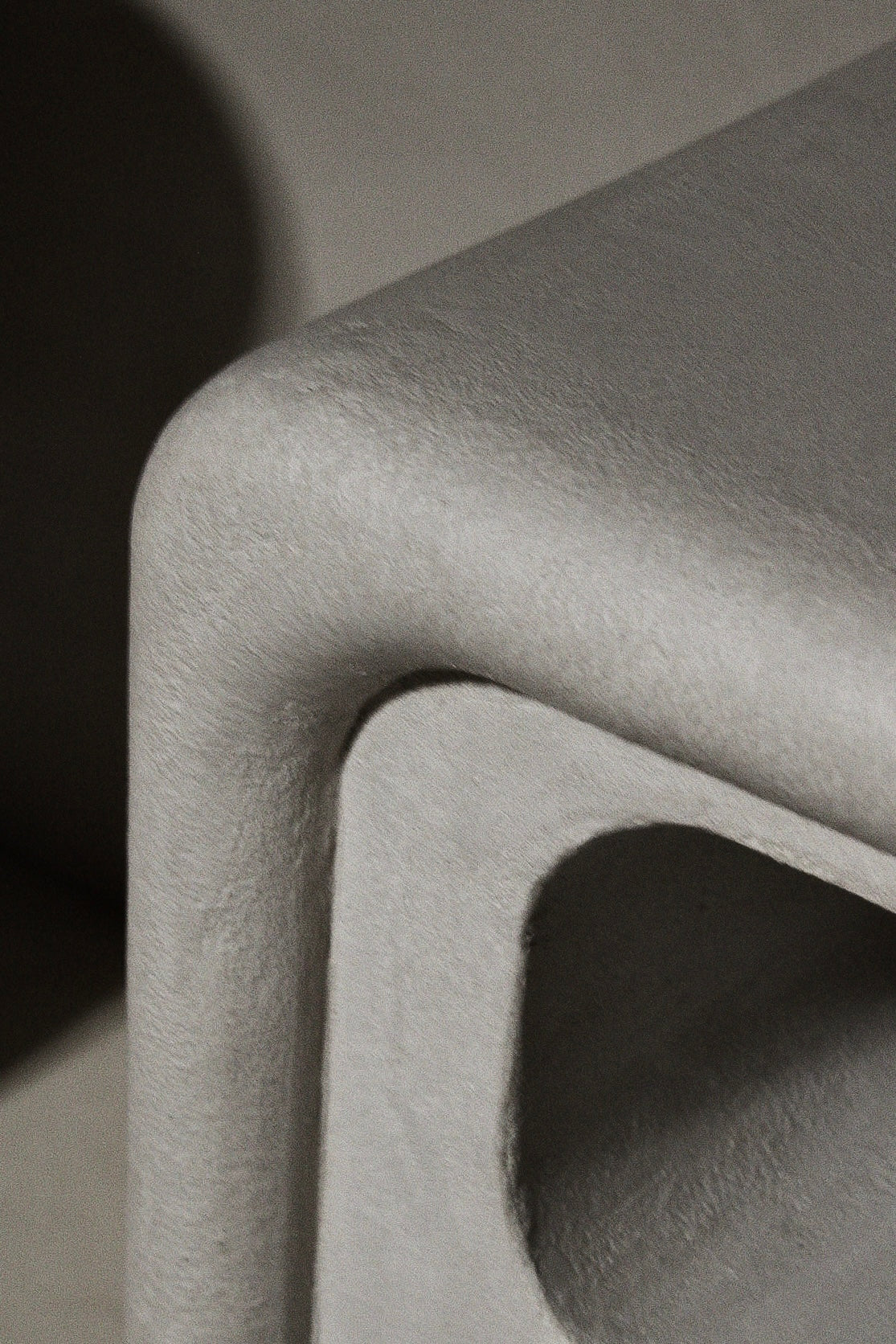 Close-up of Clay Duvet showing a subtle, fine grain across its tactile surface and softly rounded edge.