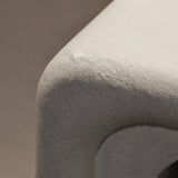 Close-up of Clay Duvet showing a subtle, fine grain across its tactile surface and softly rounded edge.