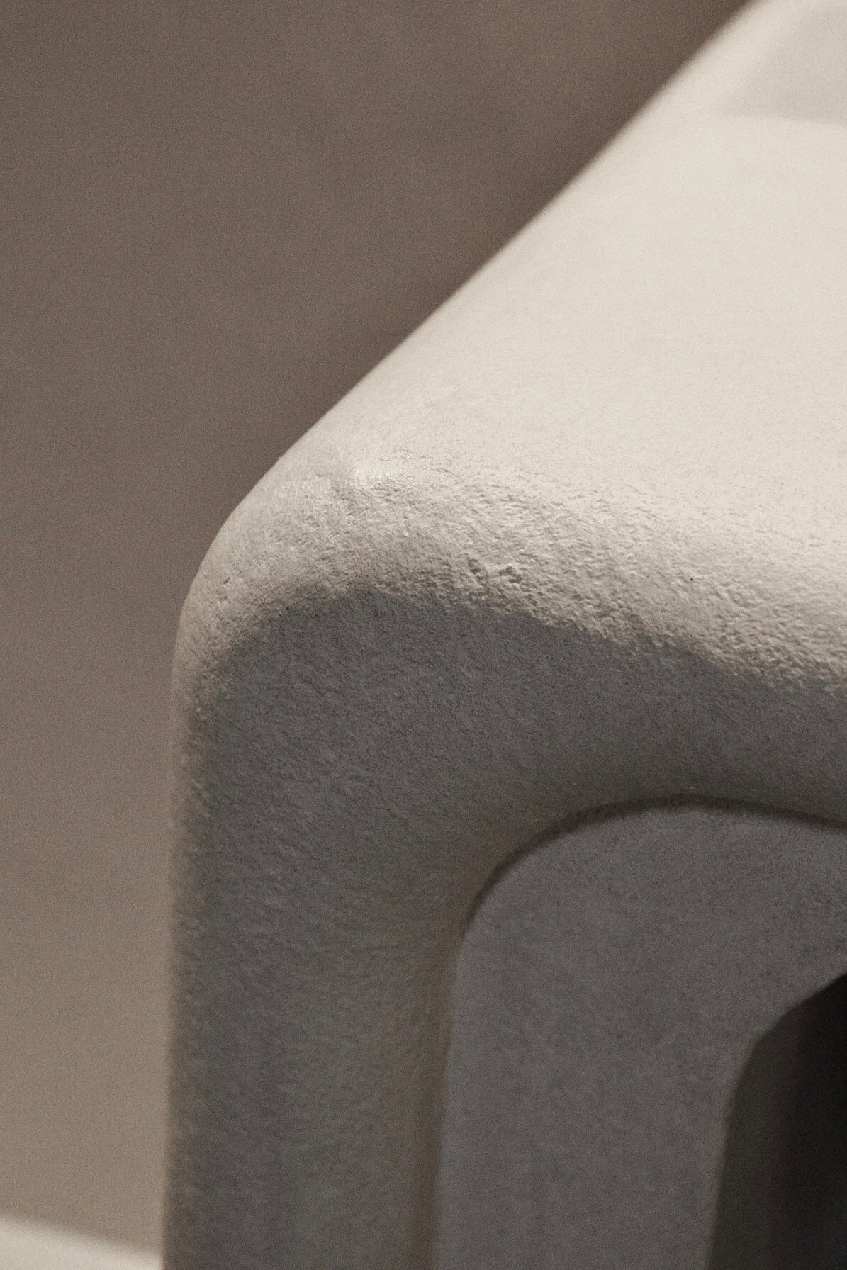 Close-up of Clay Duvet showing a subtle, fine grain across its tactile surface and softly rounded edge.