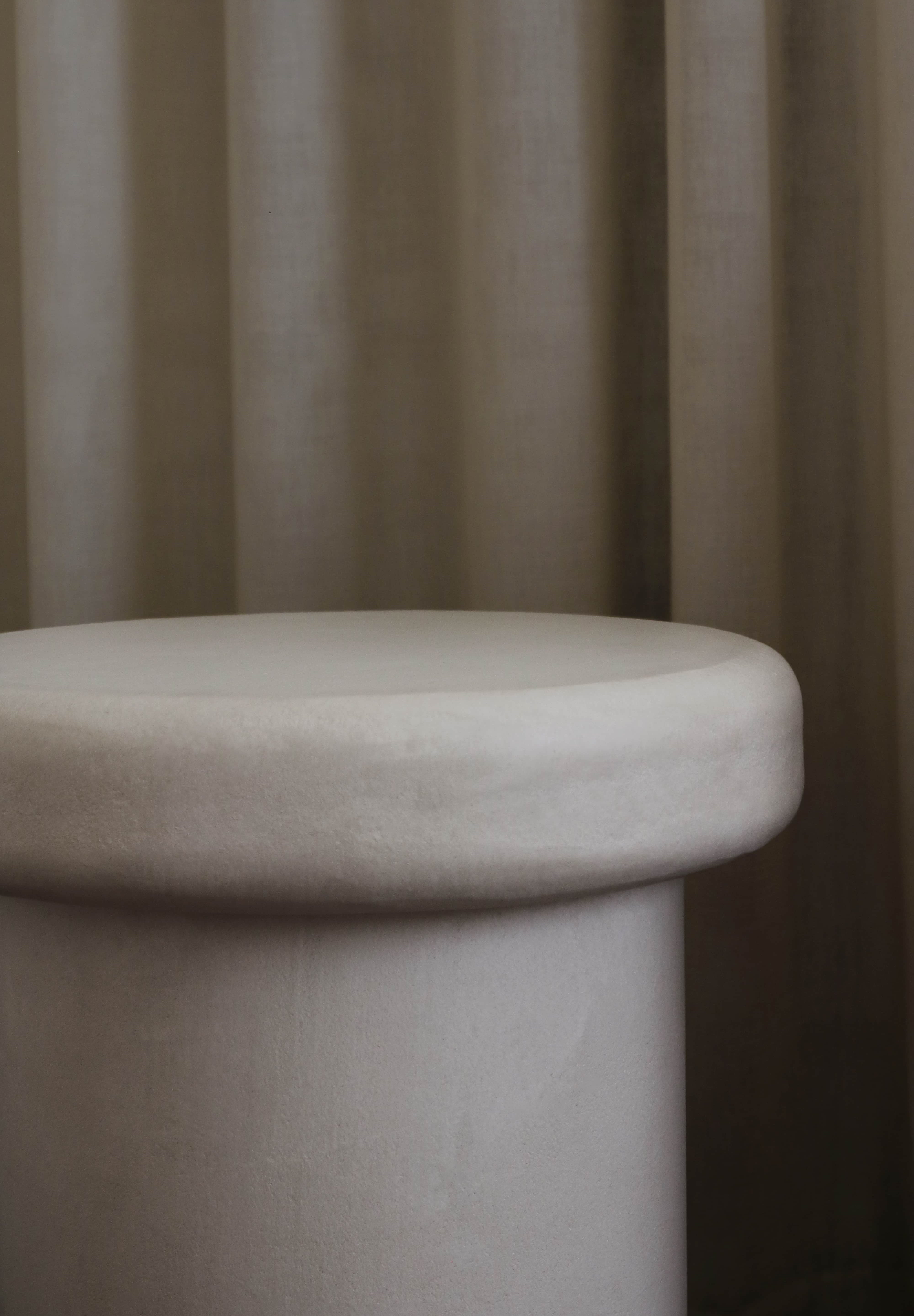 Close-up of Clay Duvet showing a subtle, fine grain across its tactile surface and softly rounded edge.