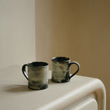 Close-up of MAIE Clay Duvet showing a subtle fine grain across the softly rounded edge of a sculptural sideboard.