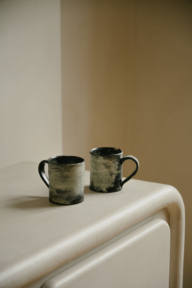 Close-up of MAIE Clay Duvet showing a subtle fine grain across the softly rounded edge of a sculptural sideboard.