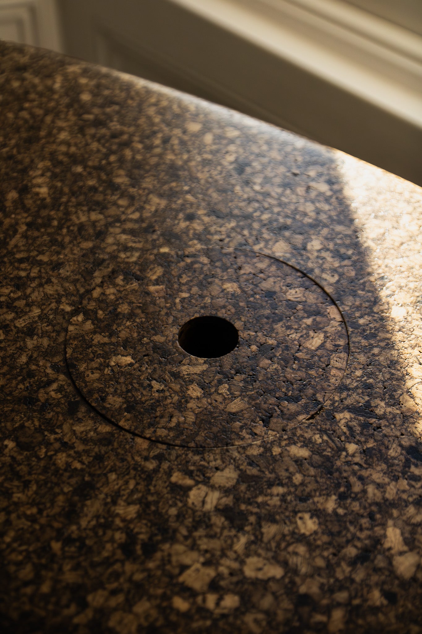 Close-up of Espresso cork showing its tactile, mottled texture and satin finish reflecting natural light.