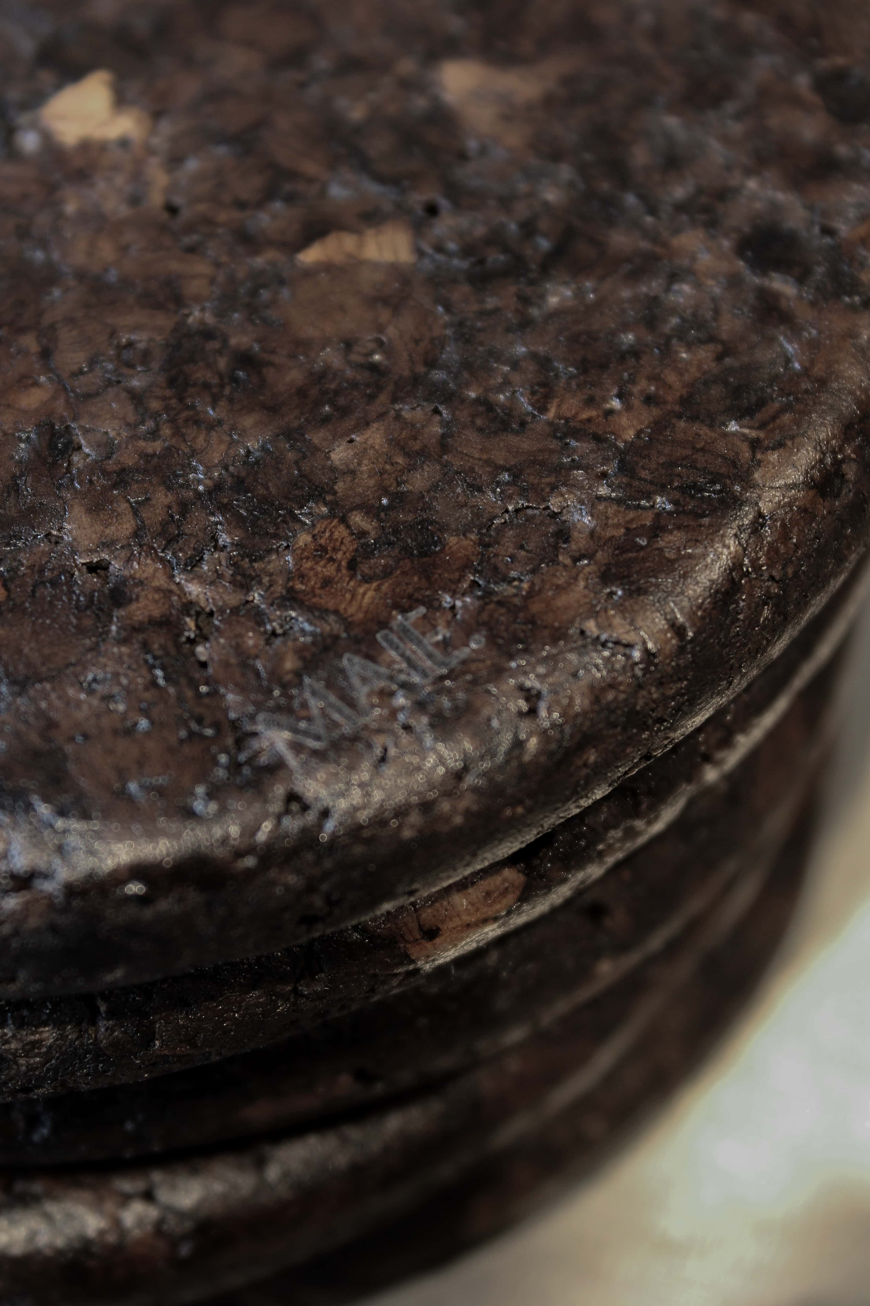 Close-up of Espresso cork showing its tactile, mottled texture and satin finish reflecting natural light.