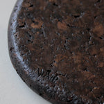 Close-up of Espresso cork showing its tactile, mottled texture and satin finish reflecting natural light.