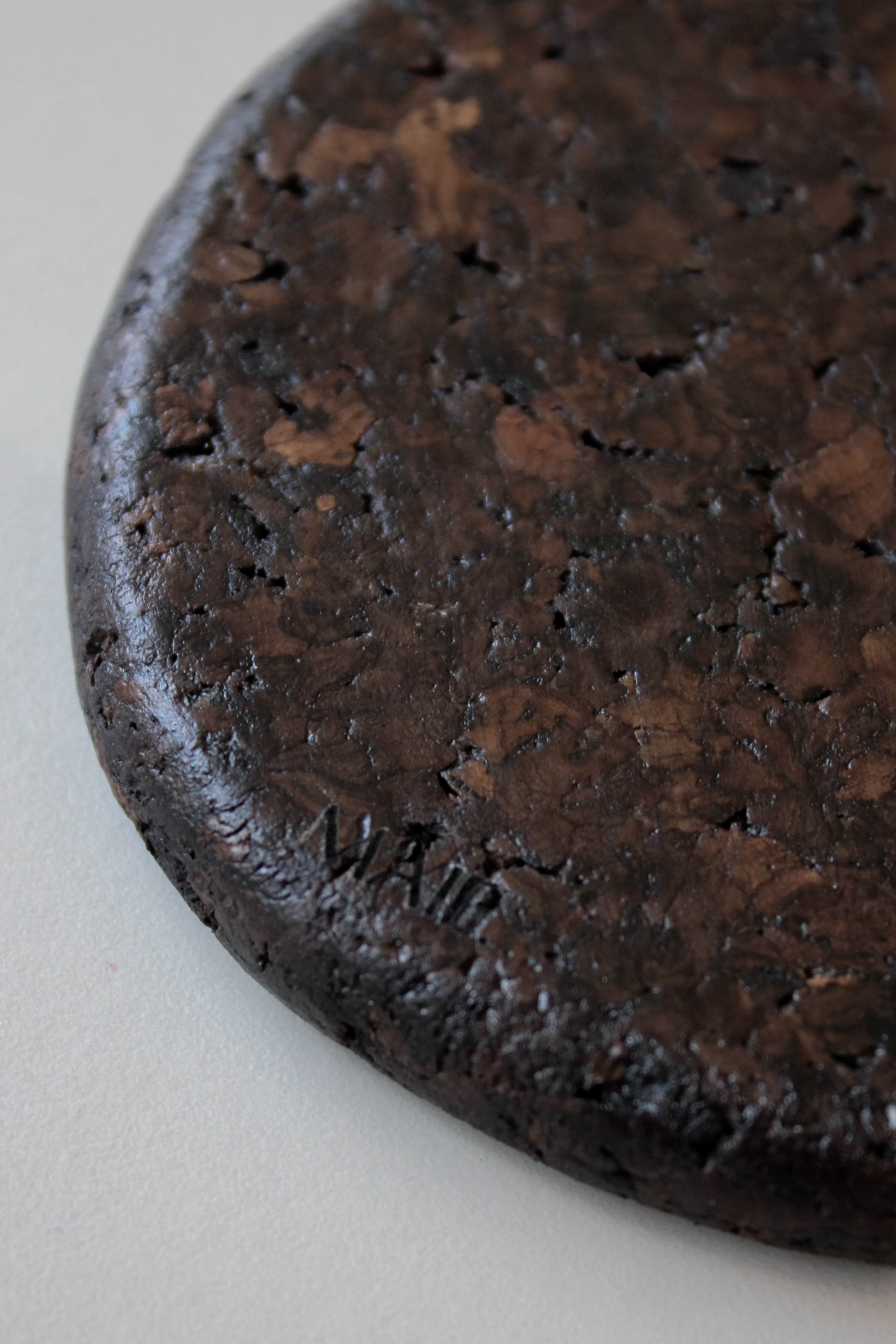 Close-up of Espresso cork showing its tactile, mottled texture and satin finish reflecting natural light.