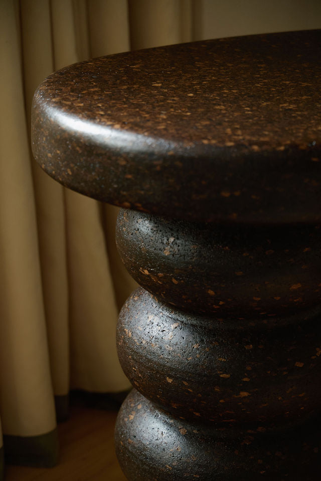 Close-up of Espresso cork showing its tactile, mottled texture and satin finish reflecting natural light.