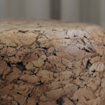 Close-up of Grain cork showing its layered, irregular texture and warm brown tones.