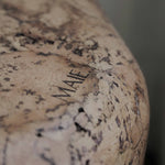Close-up of Grain cork showing its layered, irregular texture and warm brown tones.