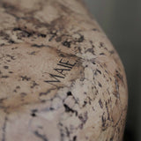 Close-up of Grain cork showing its layered, irregular texture and warm brown tones.