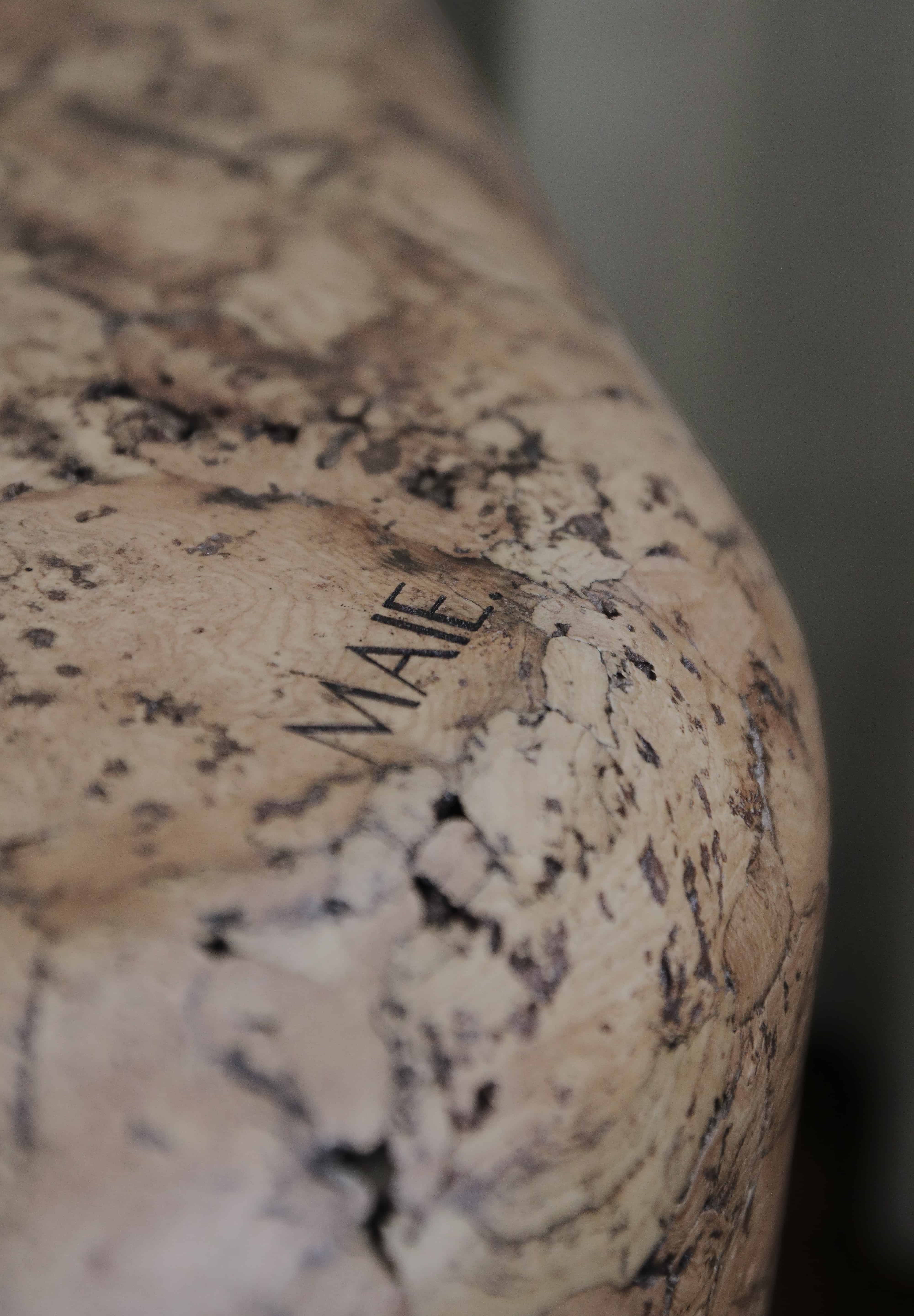 Close-up of Grain cork showing its layered, irregular texture and warm brown tones.