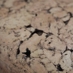 Close-up of Grain cork showing its layered, irregular texture and warm brown tones.