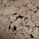 Close-up of Grain cork showing its layered, irregular texture and warm brown tones.