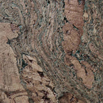 Close-up of the Marbled cork coaster showing soft green lines through warm cork grain and tactile texture.