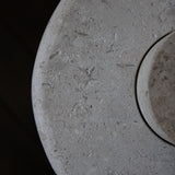 Close-up of the honed Limestone Portland Side Table top, with fossil-like inclusions and subtle grey-beige tonal variation.