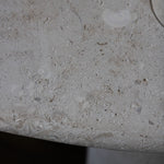 Close-up of the honed Limestone Portland Side Table top, with fossil-like inclusions and subtle grey-beige tonal variation.