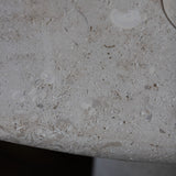 Close-up of the honed Limestone Portland Side Table top, with fossil-like inclusions and subtle grey-beige tonal variation.