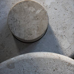 Close-up of the honed Limestone Portland Side Table top, with fossil-like inclusions and subtle grey-beige tonal variation.