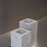 Two honed Limestone Portland Cube Holders with open tops and softly textured, pale grey-beige surfaces.