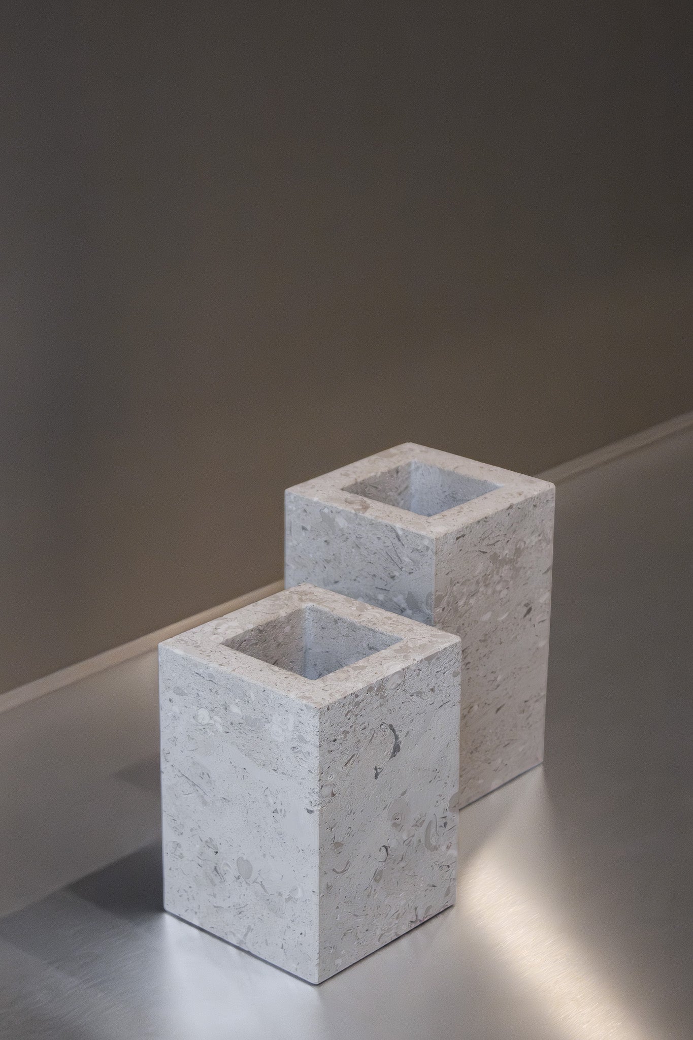 Two honed Limestone Portland Cube Holders with open tops and softly textured, pale grey-beige surfaces.