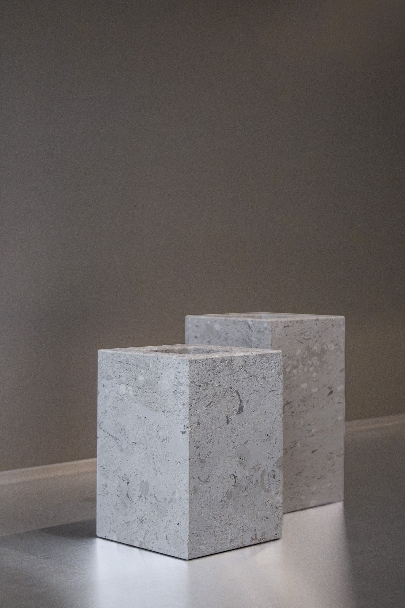 Two honed Limestone Portland Cube Holders with open tops and softly textured, pale grey-beige surfaces.