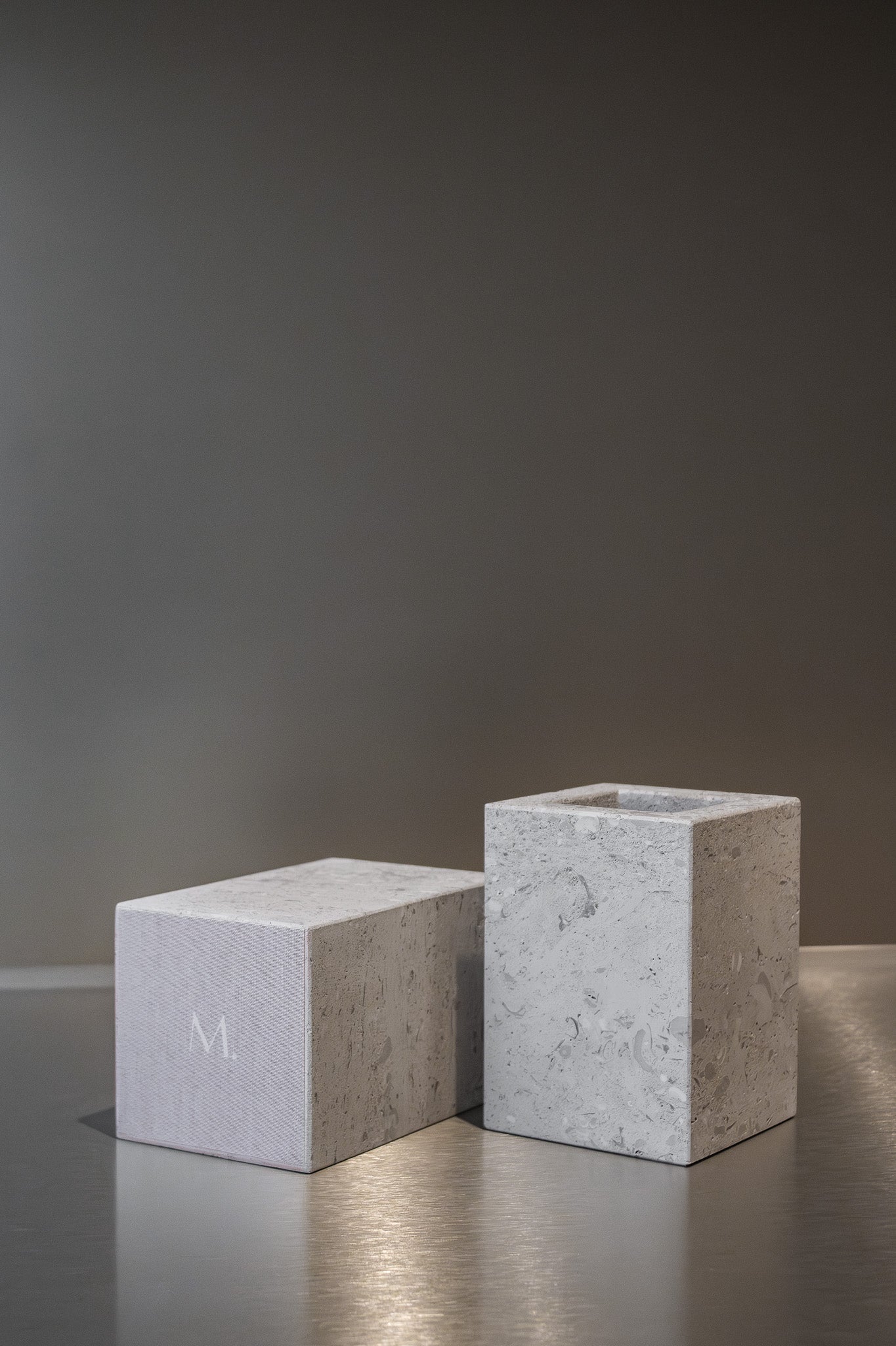 Two honed Limestone Portland Cube Holders with open tops and softly textured, pale grey-beige surfaces.