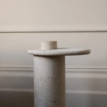 Honed Limestone Portland Side Table with an organically shaped tabletop and cylindrical pedestal, in pale grey-beige stone.