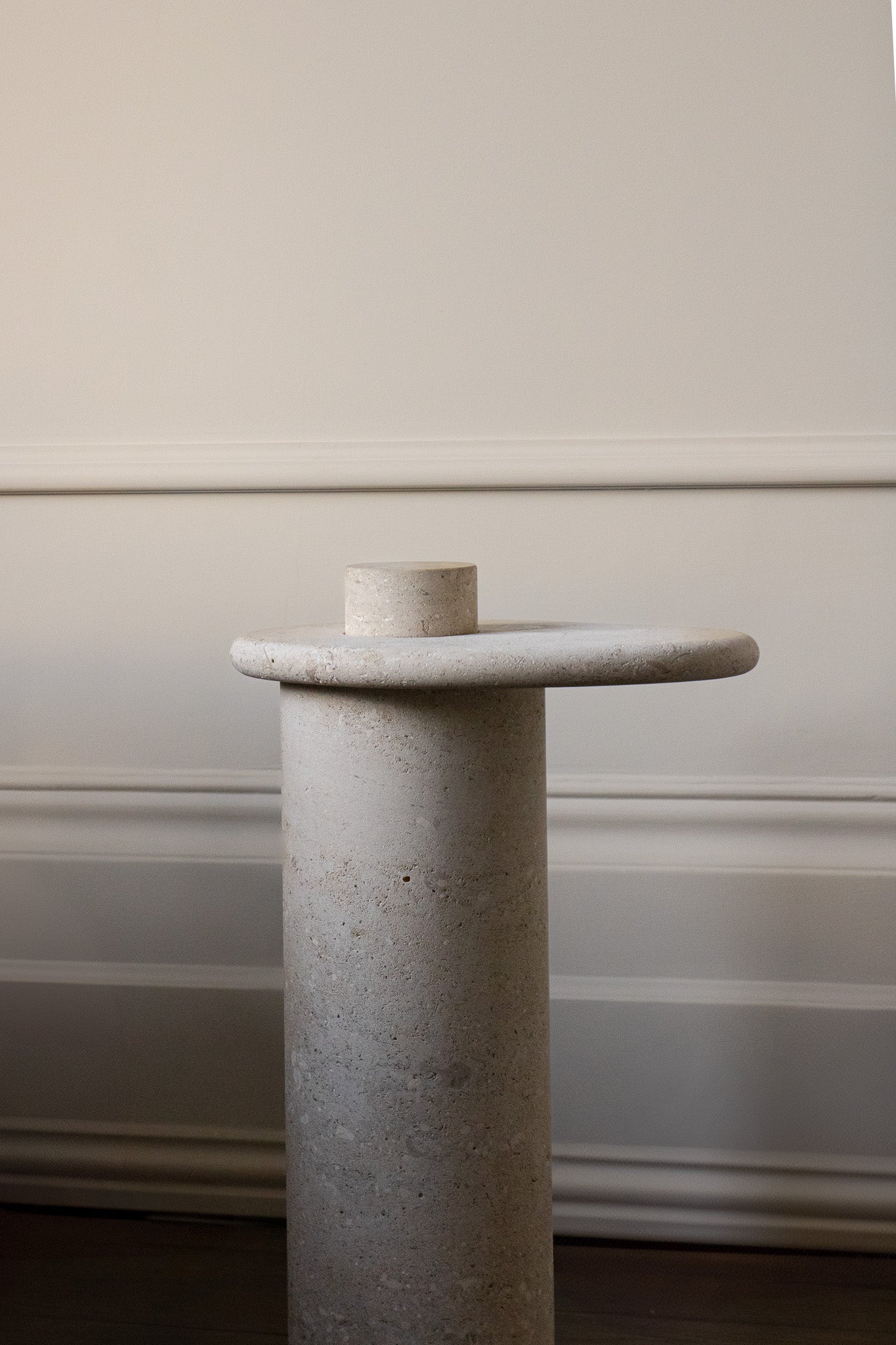 Honed Limestone Portland Side Table with an organically shaped tabletop and cylindrical pedestal, in pale grey-beige stone.
