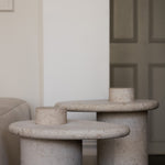 Honed Limestone Portland Side Table with an organically shaped tabletop and cylindrical pedestal, in pale grey-beige stone.