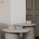 Honed Limestone Portland Side Table with an organically shaped tabletop and cylindrical pedestal, in pale grey-beige stone.