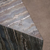 Close-up of Travertino Marrone showing natural pores, irregular veining and layered grey-brown tones along stacked stone edges.