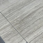 Close-up of Travertino Silver showing soft grey veining, natural pores and tonal variation.