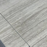 Close-up of Travertino Silver showing soft grey veining, natural pores and tonal variation.