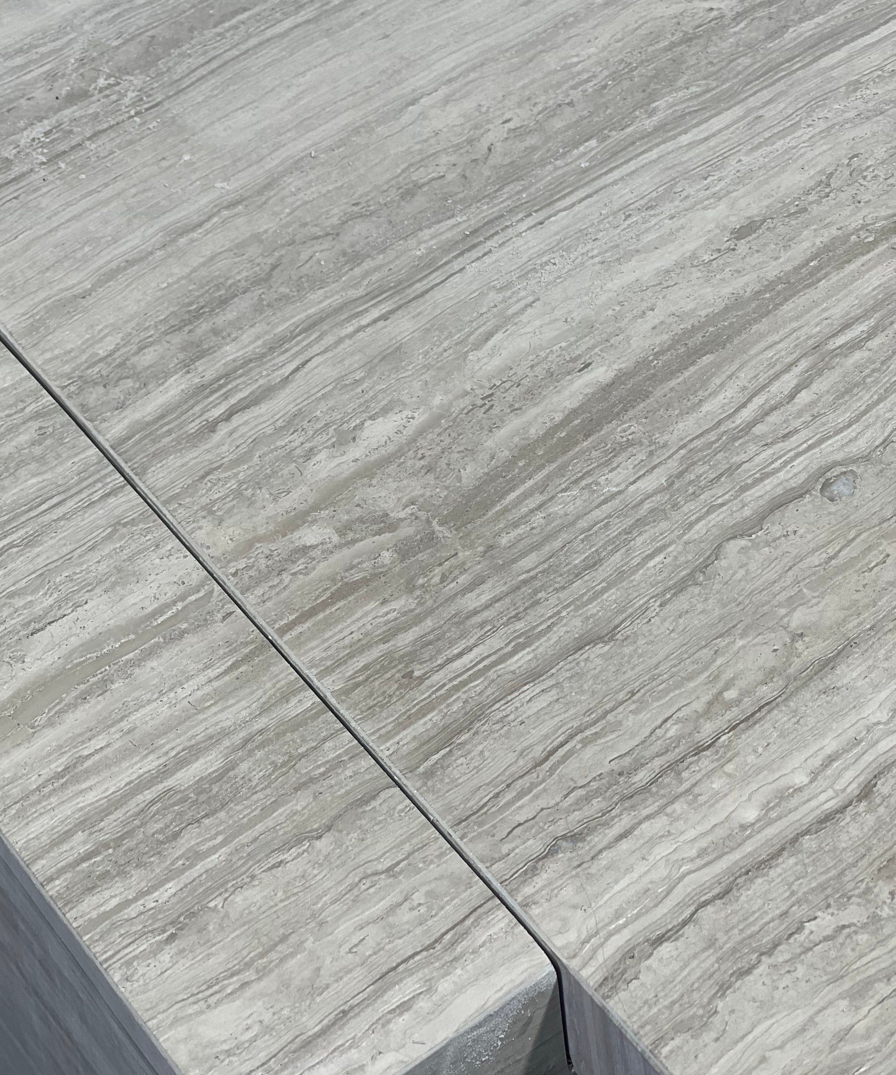 Close-up of Travertino Silver showing soft grey veining, natural pores and tonal variation.
