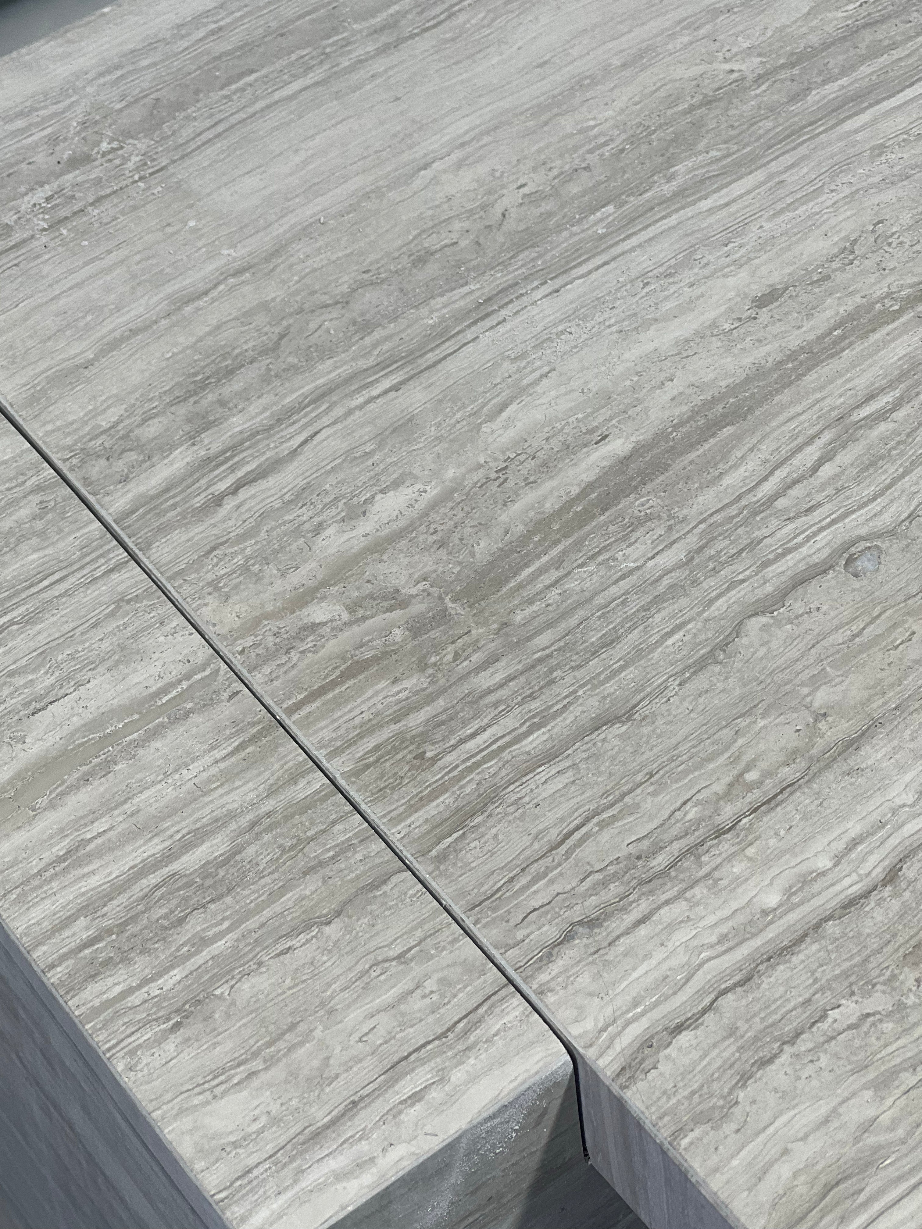 Close-up of Travertino Silver showing soft grey veining, natural pores and tonal variation.
